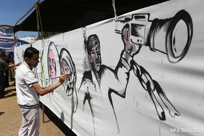 A Palestinian artist paints a mural in solidarity with Palestinian prisoners on hunger strike in Israeli jails, and to commemorate the 68th anniversary of the "Nakba" or "catastrophe" in Arabic in reference to the establ...