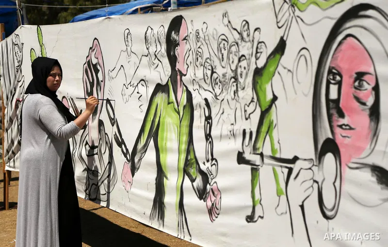 A Palestinian artist paints a mural in solidarity with Palestinian prisoners on hunger strike in Israeli jails, and to commemorate the 68th anniversary of the "Nakba" or "catastrophe" in Arabic in reference to the establ...