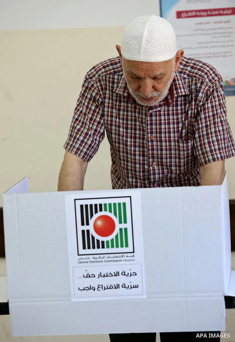 A Palestinian man casts his ballot at a polling station during municipal elections in the West Bank of Nablus on May 13, 2017. Photo by Ayman Ameen