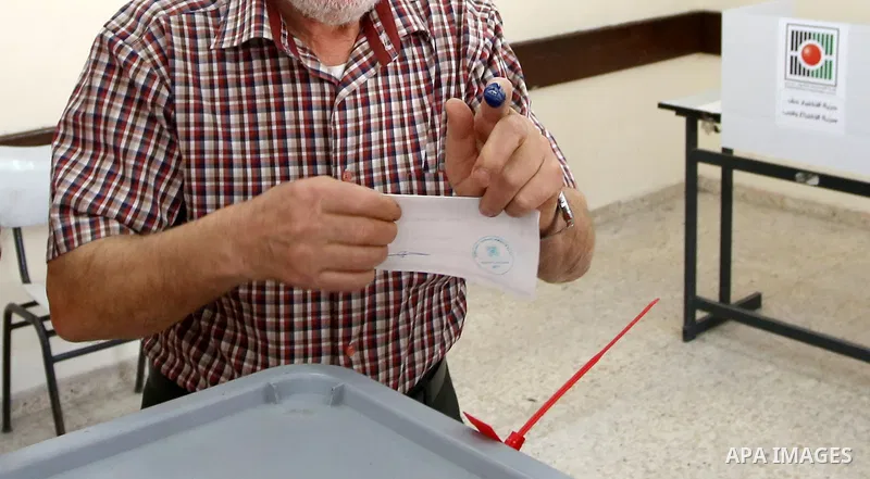 A Palestinian man casts his ballot at a polling station during municipal elections in the West Bank of Nablus on May 13, 2017. Photo by Ayman Ameen