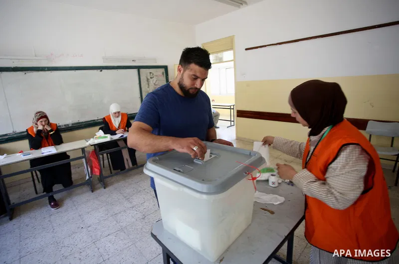 A Palestinian man casts his ballot at a polling station during municipal elections in the West Bank of Nablus on May 13, 2017. Photo by Ayman Ameen