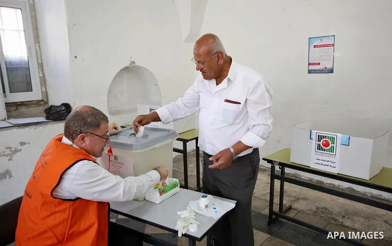 A Palestinian man casts his ballot at a polling station during municipal elections in the West Bank of Nablus on May 13, 2017. Photo by Ayman Ameen