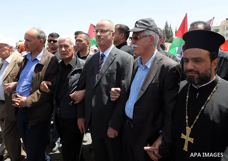 Palestinian Prime Minister Rami Hamdallah takes part in a rally to mark the 69th anniversary of the "Nakba" or "catastrophe" in Arabic in reference to the establishment in 1948 of the state of Israel, in the West Bank ci...