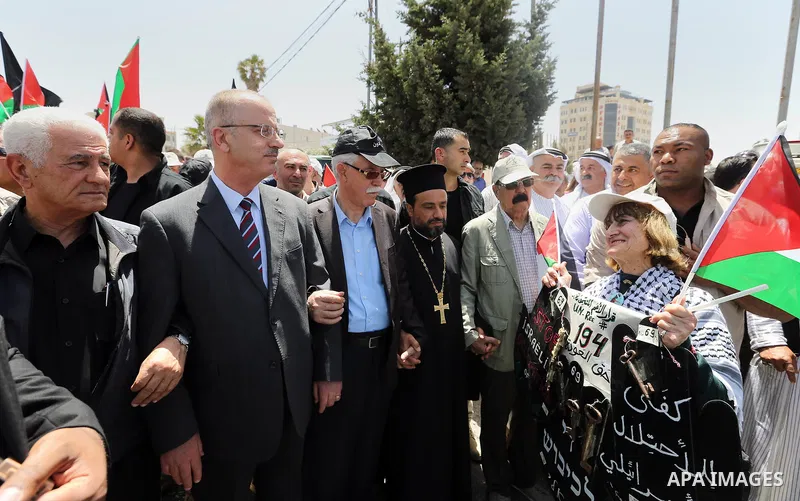 Palestinian Prime Minister Rami Hamdallah takes part in a rally to mark the 69th anniversary of the "Nakba" or "catastrophe" in Arabic in reference to the establishment in 1948 of the state of Israel, in the West Bank ci...