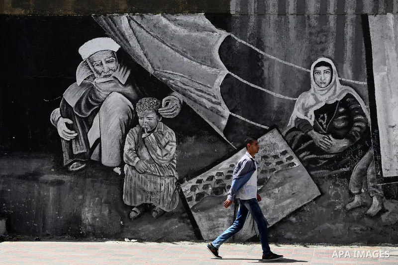 A Palestinian man walks past a mural on the occasion of the 69th anniversary of the "Nakba" or "catastrophe" in Arabic in reference to the establishment in 1948 of the state of Israel, in Gaza city on May 15, 2017. Nakba...