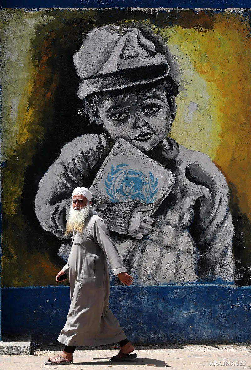 A Palestinian man walks past a mural on the occasion of the 69th anniversary of the "Nakba" or "catastrophe" in Arabic in reference to the establishment in 1948 of the state of Israel, in Gaza city on May 15, 2017. Nakba...