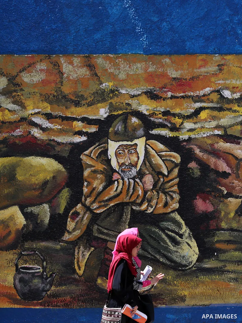 Palestinian women walk past a mural on the occasion of the 69th anniversary of the "Nakba" or "catastrophe" in Arabic in reference to the establishment in 1948 of the state of Israel, in Gaza city on May 15, 2017. Nakba"...