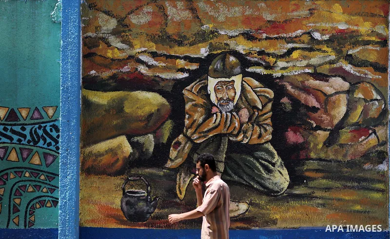 A Palestinian man walks past a mural on the occasion of the 69th anniversary of the "Nakba" or "catastrophe" in Arabic in reference to the establishment in 1948 of the state of Israel, in Gaza city on May 15, 2017. Nakba...
