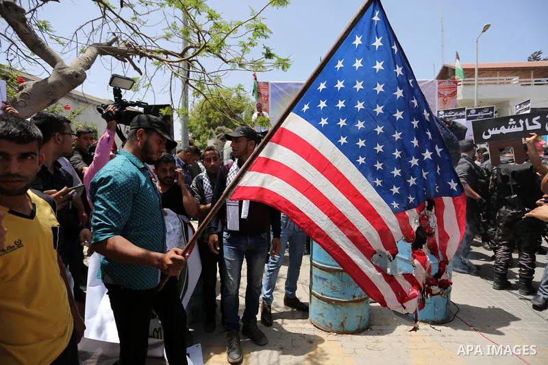 Palestinians burn American flag during a rally to commemorate the 69th anniversary of the "Nakba" in Gaza City, on May 15, 2017. "Nakba" means in Arabic "catastrophe" in reference to the birth of the state of Israel 69-y...