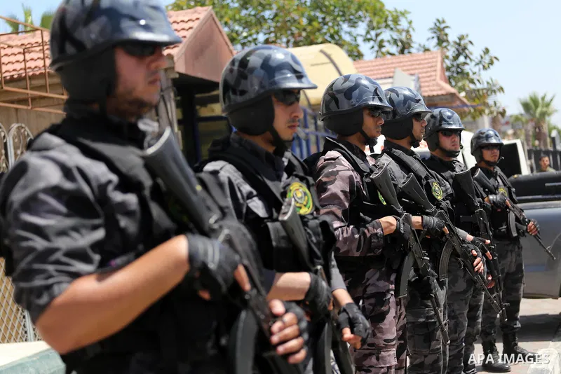 Palestinian policemen stand guard during a press conference to detect details of the killing one of its key military commanders, Mazen Faqha, who was shot dead on March 24, 2017 near his home in Gaza City on May 16, 2017...