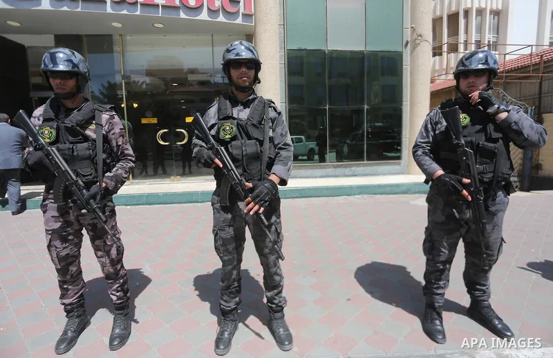 Palestinian policemen stand guard during a press conference to detect details of the killing one of its key military commanders, Mazen Faqha, who was shot dead on March 24, 2017 near his home in Gaza City on May 16, 2017...