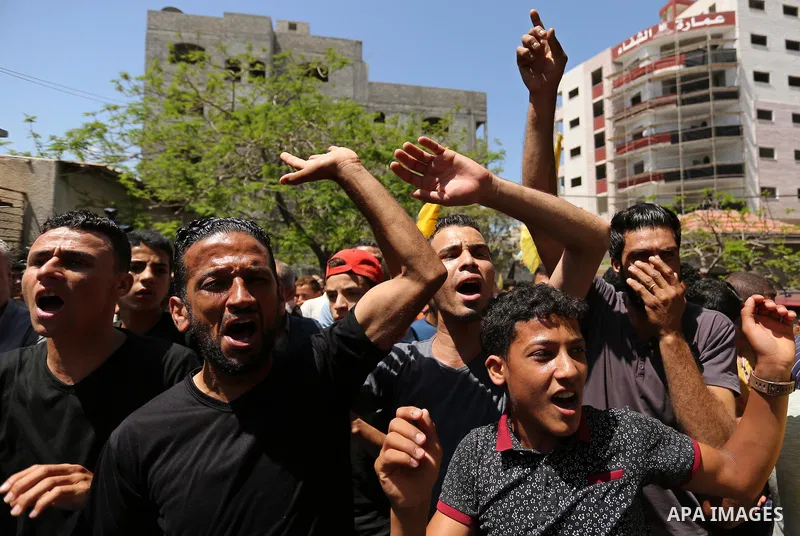 Palestinian mourners carry the body of Mohammed Majed Bakr, a 25-year-old fisherman who died from his injuries after an Israeli patrol vessel fired at a fishing boat, during his funeral in Gaza City on May 16, 2017. The...