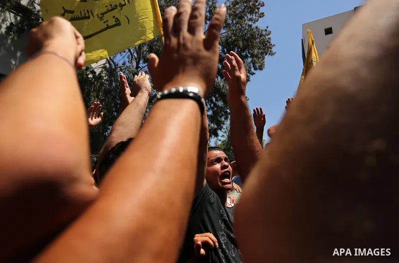 Palestinian mourners carry the body of Mohammed Majed Bakr, a 25-year-old fisherman who died from his injuries after an Israeli patrol vessel fired at a fishing boat, during his funeral in Gaza City on May 16, 2017. The...