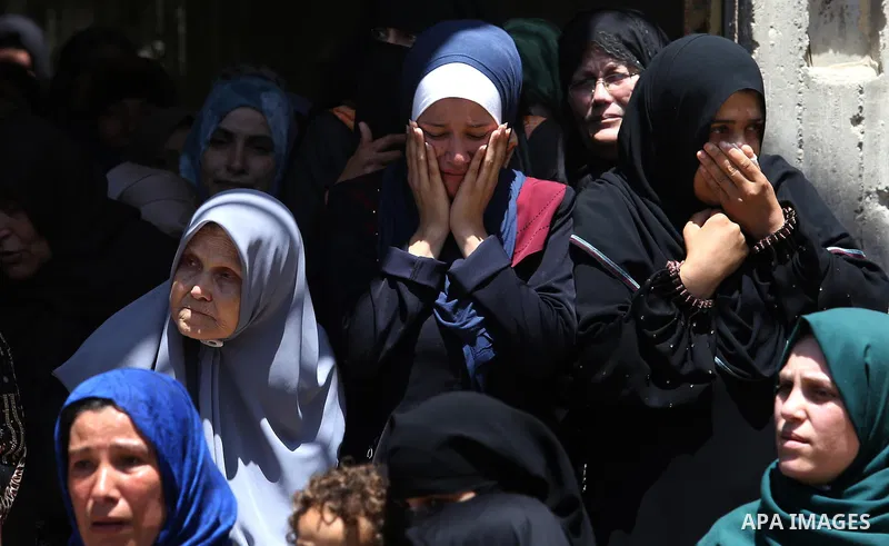 Palestinian women mourn during the funeral of Mohammed Majed Bakr, a 25-year-old fisherman who died from his injuries after an Israeli patrol vessel fired at a fishing boat, in Gaza city on May 16, 2017. The Israeli patr...