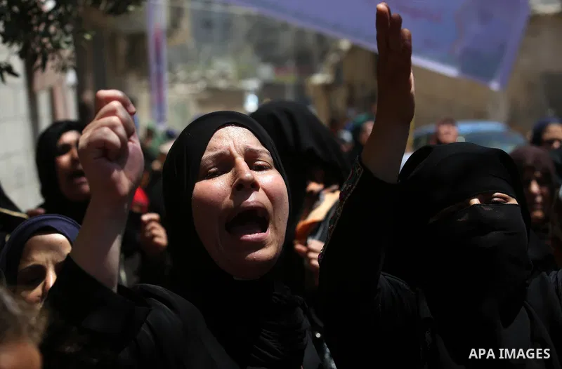 Palestinian women mourn during the funeral of Mohammed Majed Bakr, a 25-year-old fisherman who died from his injuries after an Israeli patrol vessel fired at a fishing boat, in Gaza city on May 16, 2017. The Israeli patr...