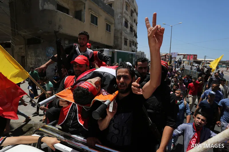 Palestinian mourners carry the body of Mohammed Majed Bakr, a 25-year-old fisherman who died from his injuries after an Israeli patrol vessel fired at a fishing boat, during his funeral in Gaza City on May 16, 2017. The...