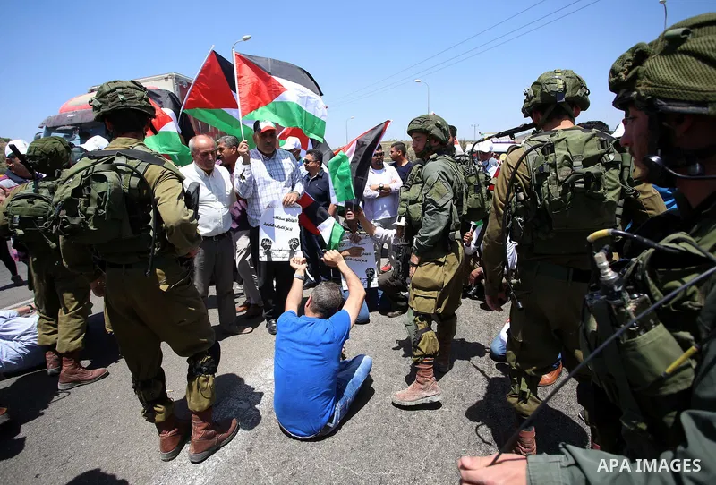 Israeli soldiers scuffle with Palestinian protesters trying to block the main road between the West Bank city of Nablus and the Jewish settlement of Shavi Shamron during a demonstration in solidarity with Palestinian pri...