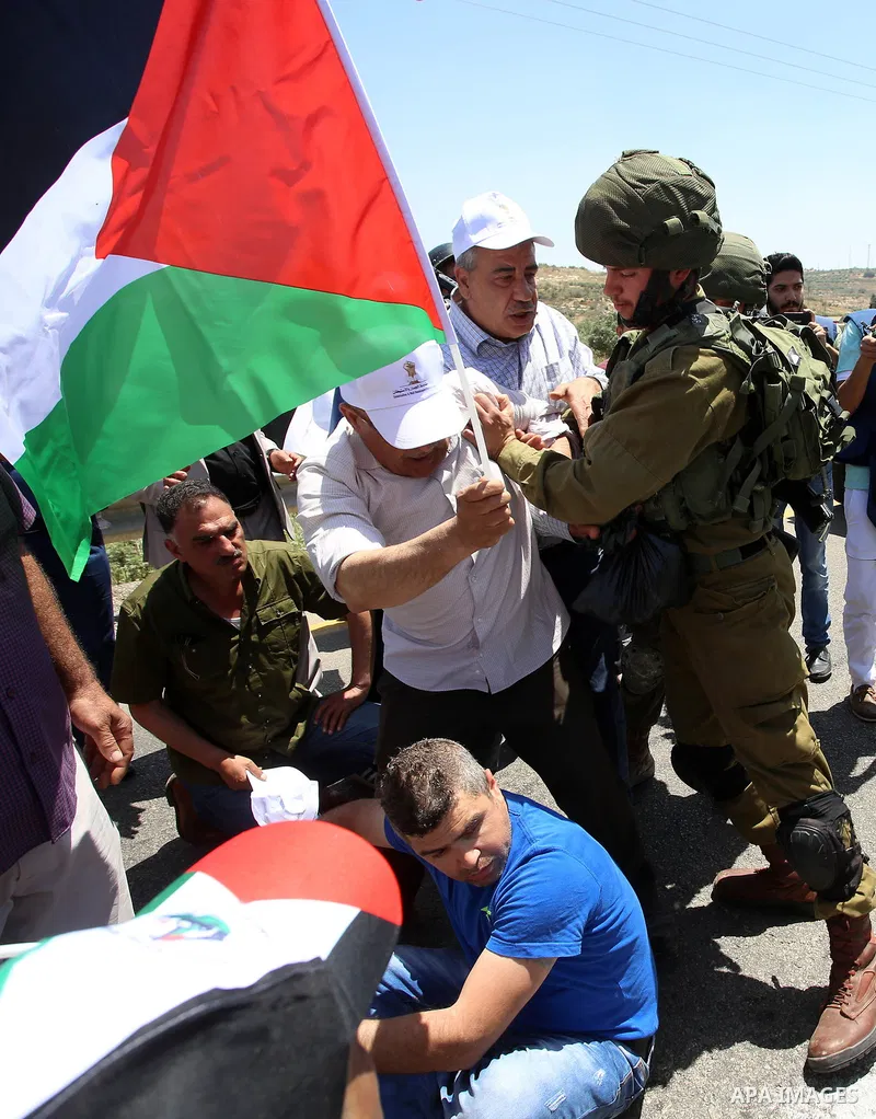 Israeli soldiers scuffle with Palestinian protesters trying to block the main road between the West Bank city of Nablus and the Jewish settlement of Shavi Shamron during a demonstration in solidarity with Palestinian pri...