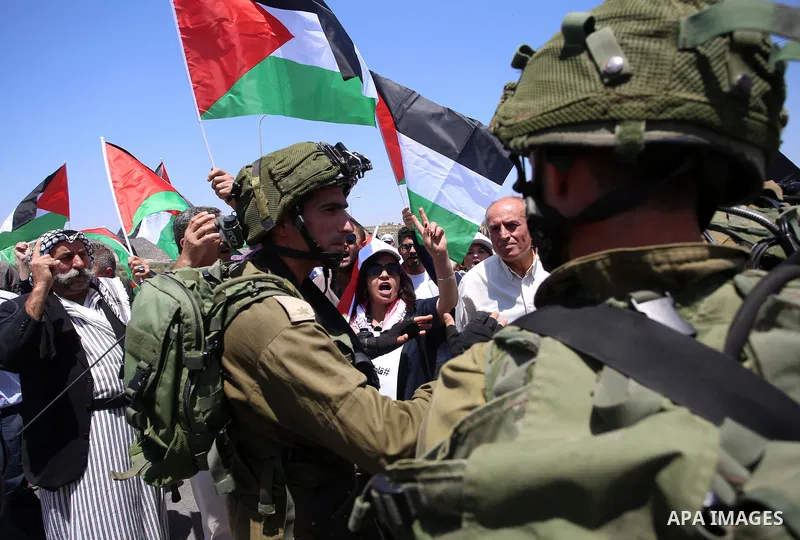 Israeli soldiers scuffle with Palestinian protesters trying to block the main road between the West Bank city of Nablus and the Jewish settlement of Shavi Shamron during a demonstration in solidarity with Palestinian pri...