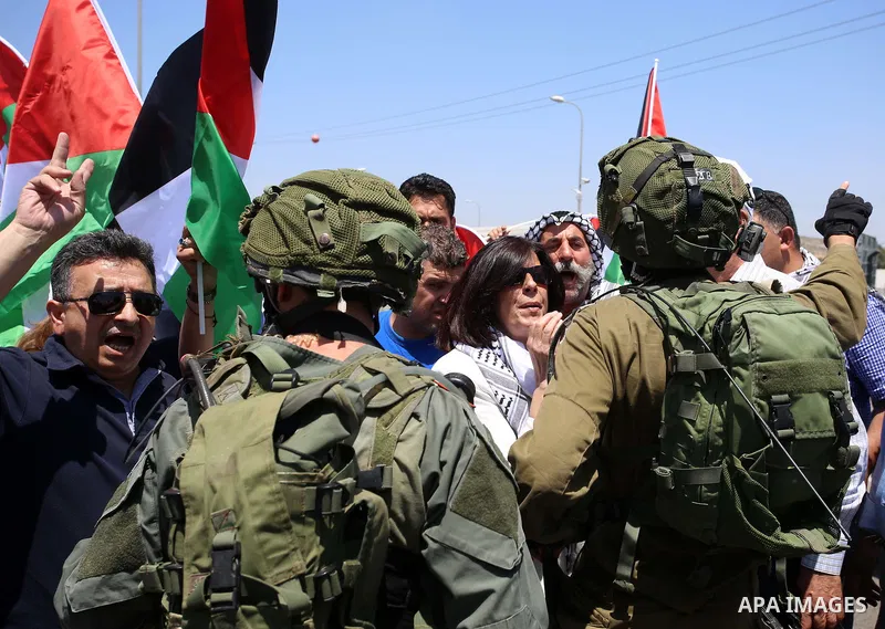Israeli soldiers scuffle with Palestinian protesters trying to block the main road between the West Bank city of Nablus and the Jewish settlement of Shavi Shamron during a demonstration in solidarity with Palestinian pri...