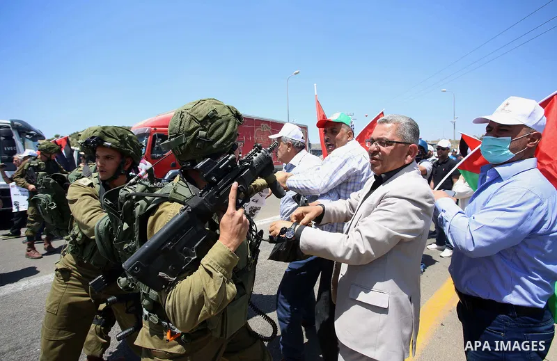 Israeli soldiers scuffle with Palestinian protesters trying to block the main road between the West Bank city of Nablus and the Jewish settlement of Shavi Shamron during a demonstration in solidarity with Palestinian pri...