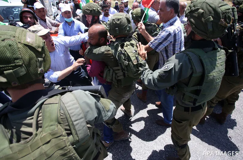 Israeli soldiers scuffle with Palestinian protesters trying to block the main road between the West Bank city of Nablus and the Jewish settlement of Shavi Shamron during a demonstration in solidarity with Palestinian pri...