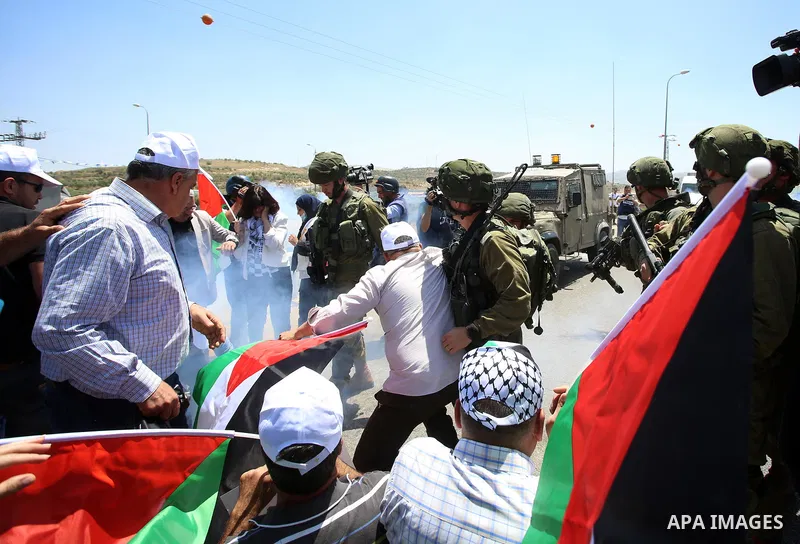 Israeli soldiers scuffle with Palestinian protesters trying to block the main road between the West Bank city of Nablus and the Jewish settlement of Shavi Shamron during a demonstration in solidarity with Palestinian pri...