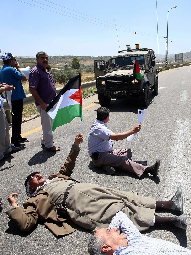 Israeli soldiers scuffle with Palestinian protesters trying to block the main road between the West Bank city of Nablus and the Jewish settlement of Shavi Shamron during a demonstration in solidarity with Palestinian pri...