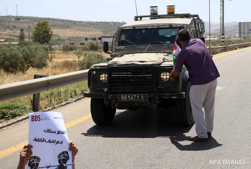 Israeli soldiers scuffle with Palestinian protesters trying to block the main road between the West Bank city of Nablus and the Jewish settlement of Shavi Shamron during a demonstration in solidarity with Palestinian pri...