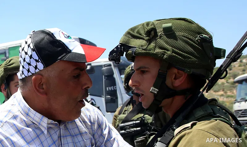 Israeli soldiers scuffle with Palestinian protesters trying to block the main road between the West Bank city of Nablus and the Jewish settlement of Shavi Shamron during a demonstration in solidarity with Palestinian pri...