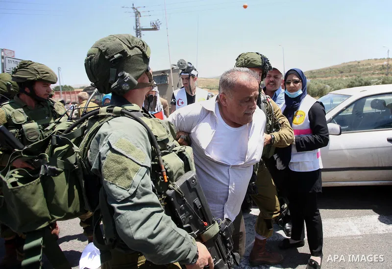 Israeli soldiers detain a Palestinian protester trying to block the main road between the West Bank city of Nablus and the Jewish settlement of Shavi Shamron during a demonstration in solidarity with Palestinian prisoner...