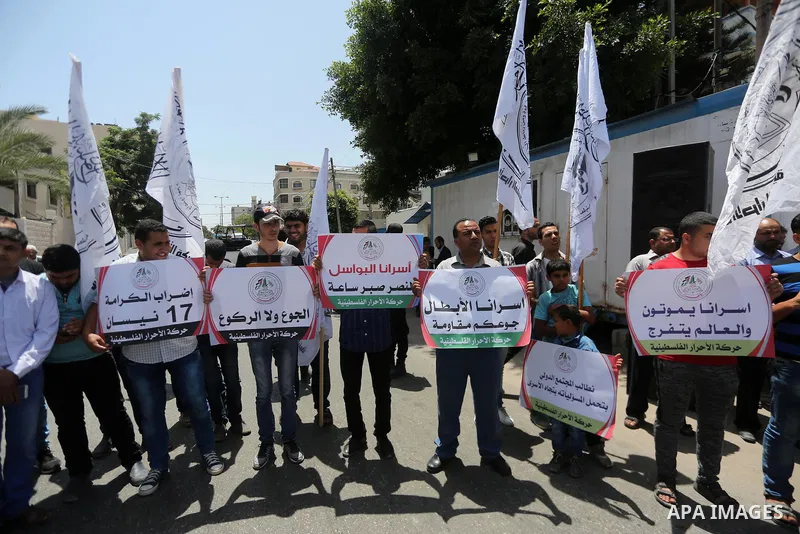 Palestinian supporters of Al-Ahrar movement take part in a protest to show solidarity with Palestinian prisoners on hunger strike in Israeli jails in front of the high commissioner for human rights headquarters, in Gaza...