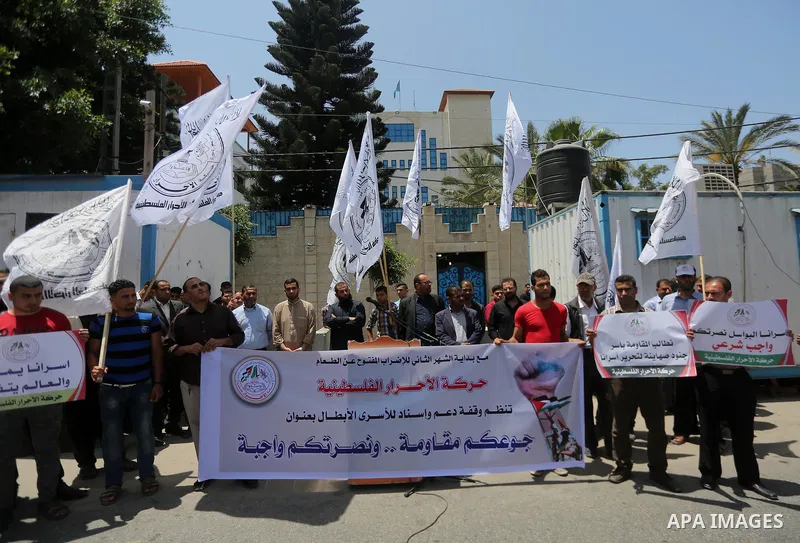 Palestinian supporters of Al-Ahrar movement take part in a protest to show solidarity with Palestinian prisoners on hunger strike in Israeli jails in front of the high commissioner for human rights headquarters, in Gaza...