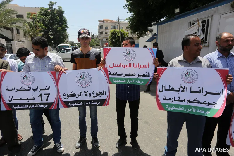 Palestinian supporters of Al-Ahrar movement take part in a protest to show solidarity with Palestinian prisoners on hunger strike in Israeli jails in front of the high commissioner for human rights headquarters, in Gaza...