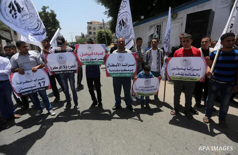 Palestinian supporters of Al-Ahrar movement take part in a protest to show solidarity with Palestinian prisoners on hunger strike in Israeli jails in front of the high commissioner for human rights headquarters, in Gaza...