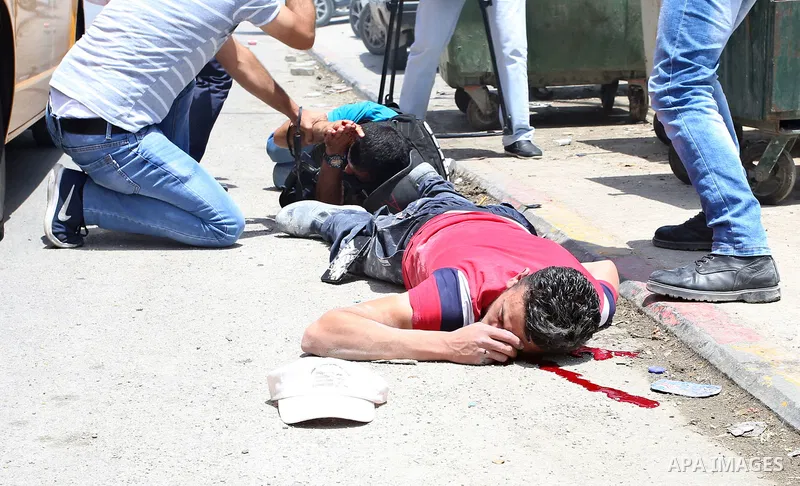 Palestinians carry a wounded photojournalist after he was allegedly killed by Israeli settler during clashes at Huwwara village, near the West Bank, 18 May 2017. According to media sources, a Palestinian was allegedly sh...