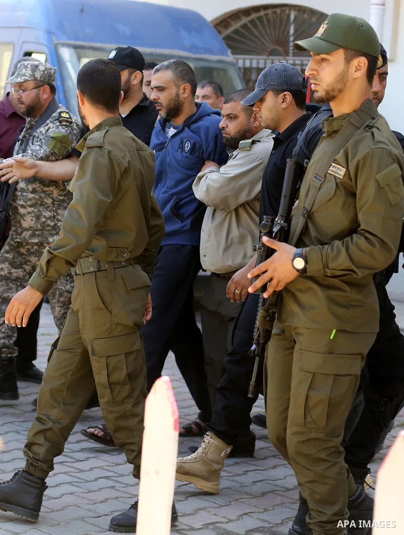 Palestinian security forces escort Abdallah al-Nashar, a Palestinian man convicted of the murder of Hamas military commander Mazen Faqha, out of the military court in Gaza City, on May 21, 2017. A court in the Gaza Strip...