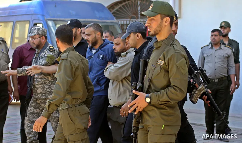 Palestinian security forces escort Abdallah al-Nashar, a Palestinian man convicted of the murder of Hamas military commander Mazen Faqha, out of the military court in Gaza City, on May 21, 2017. A court in the Gaza Strip...