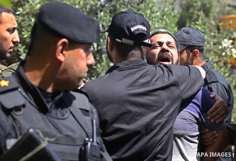 Palestinian security forces escort Hisham al-Aloul, a 44-year-old Palestinian man convicted of the murder of Hamas military commander Mazen Faqha, out of the military court in Gaza City, on May 21, 2017. A court in the G...