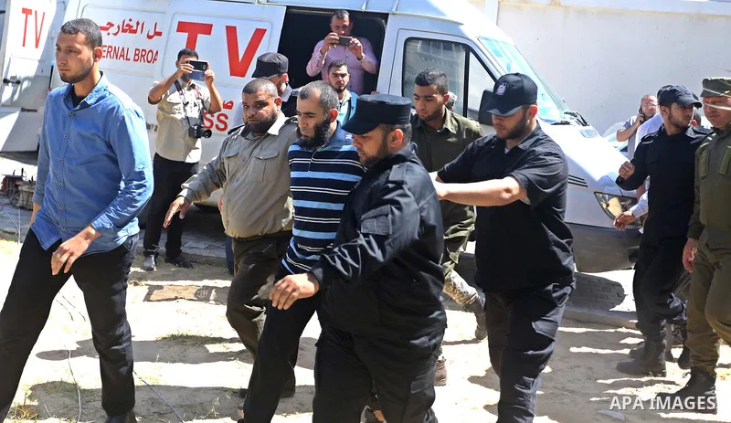 Palestinian security forces escort Ashraf Abu Leila, a 38-year-old Palestinian man convicted of the murder of Hamas military commander Mazen Faqha, out of the military court in Gaza City, on May 21, 2017. A court in the...