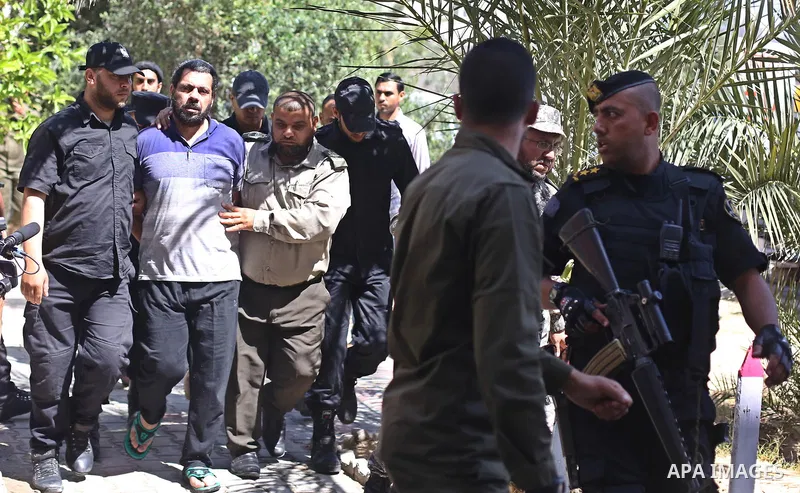 Palestinian security forces escort Hisham al-Aloul, a 44-year-old Palestinian man convicted of the murder of Hamas military commander Mazen Faqha, out of the military court in Gaza City, on May 21, 2017. A court in the G...