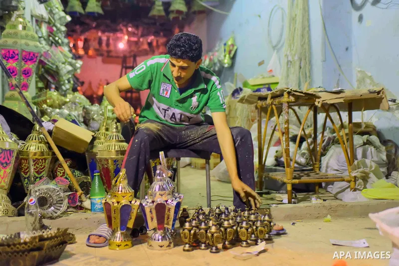 An Egyptian worker manufactures a traditional Ramadan lantern known as "Fanous" in Arabic, at his workshop ready for the month of holy Ramadan in Cairo, Egypt, on May 21, 2017. Photo by Amr Sayed