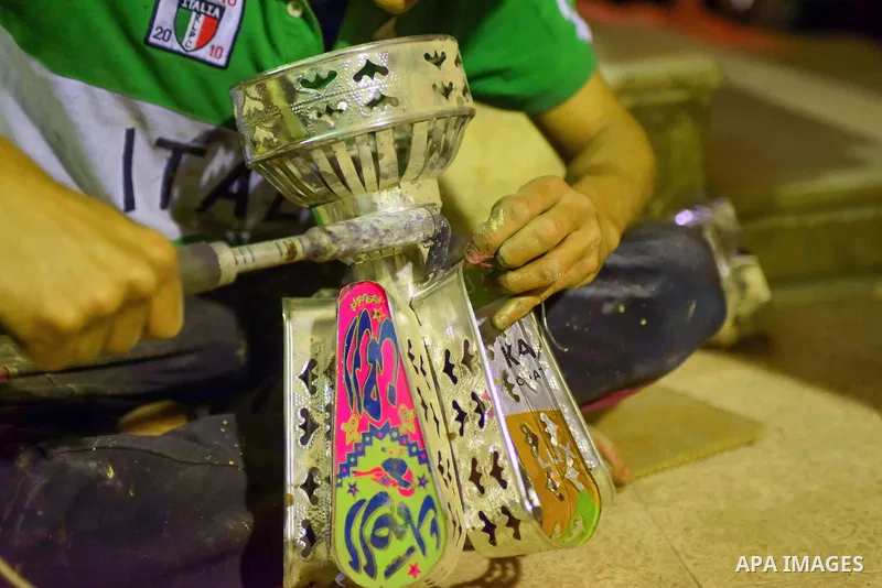 An Egyptian worker manufactures a traditional Ramadan lantern known as "Fanous" in Arabic, at his workshop ready for the month of holy Ramadan in Cairo, Egypt, on May 21, 2017. Photo by Amr Sayed