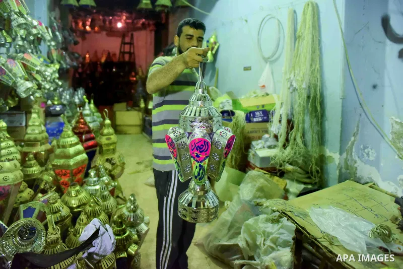 An Egyptian worker manufactures a traditional Ramadan lantern known as "Fanous" in Arabic, at his workshop ready for the month of holy Ramadan in Cairo, Egypt, on May 21, 2017. Photo by Amr Sayed