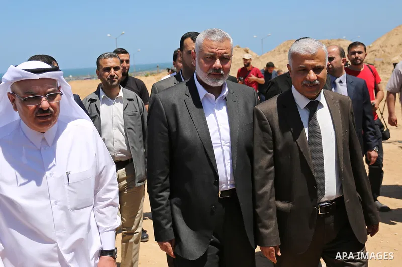Ismail Haniyeh, leader of Hamas and Qatar's Ambassador to the Palestinian Authority, Mohammed Al Emadi attend the ceremony of establishment of the headquarters of the Gaza reconstruction commission, in the west of Gaza c...