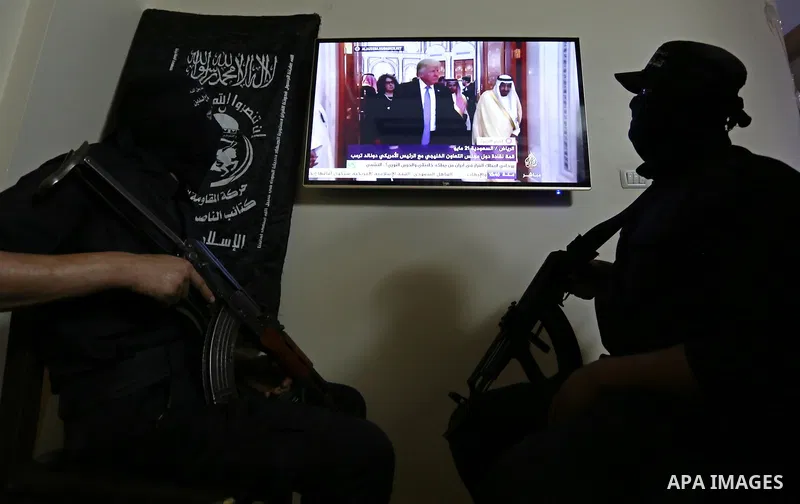 Palestinian militants of the Nasser Salah al-Din Brigades the military wing of the Popular Resistance movement watch the opening session of the Arab American Islamic summit held in the Saudi capital Riyadh, with the part...