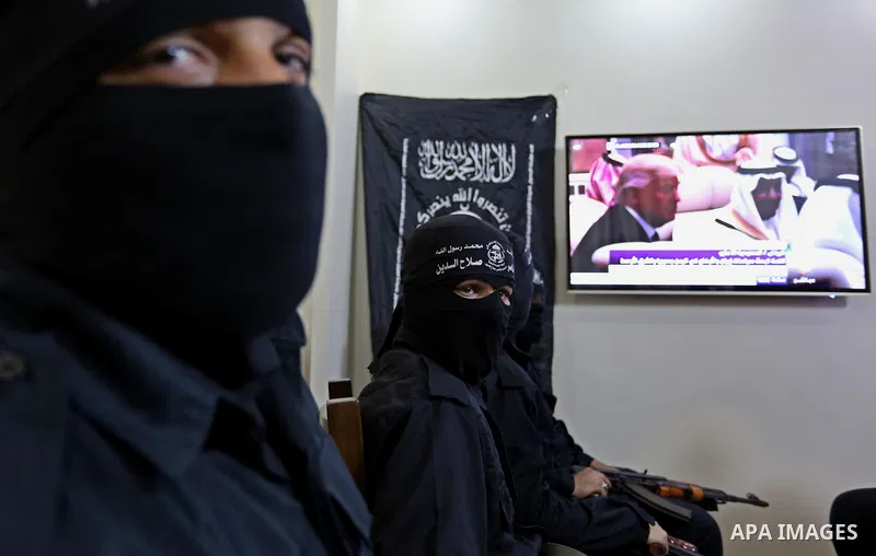 Palestinian militants of the Nasser Salah al-Din Brigades the military wing of the Popular Resistance movement watch the opening session of the Arab American Islamic summit held in the Saudi capital Riyadh, with the part...