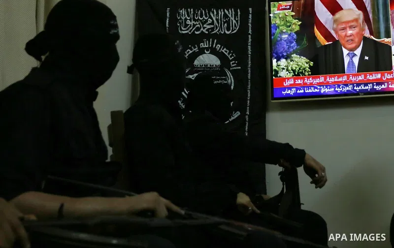 Palestinian militants of the Nasser Salah al-Din Brigades the military wing of the Popular Resistance movement watch the opening session of the Arab American Islamic summit held in the Saudi capital Riyadh, with the part...