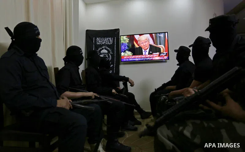 Palestinian militants of the Nasser Salah al-Din Brigades the military wing of the Popular Resistance movement watch the opening session of the Arab American Islamic summit held in the Saudi capital Riyadh, with the part...