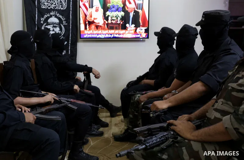 Palestinian militants of the Nasser Salah al-Din Brigades the military wing of the Popular Resistance movement watch the opening session of the Arab American Islamic summit held in the Saudi capital Riyadh, with the part...